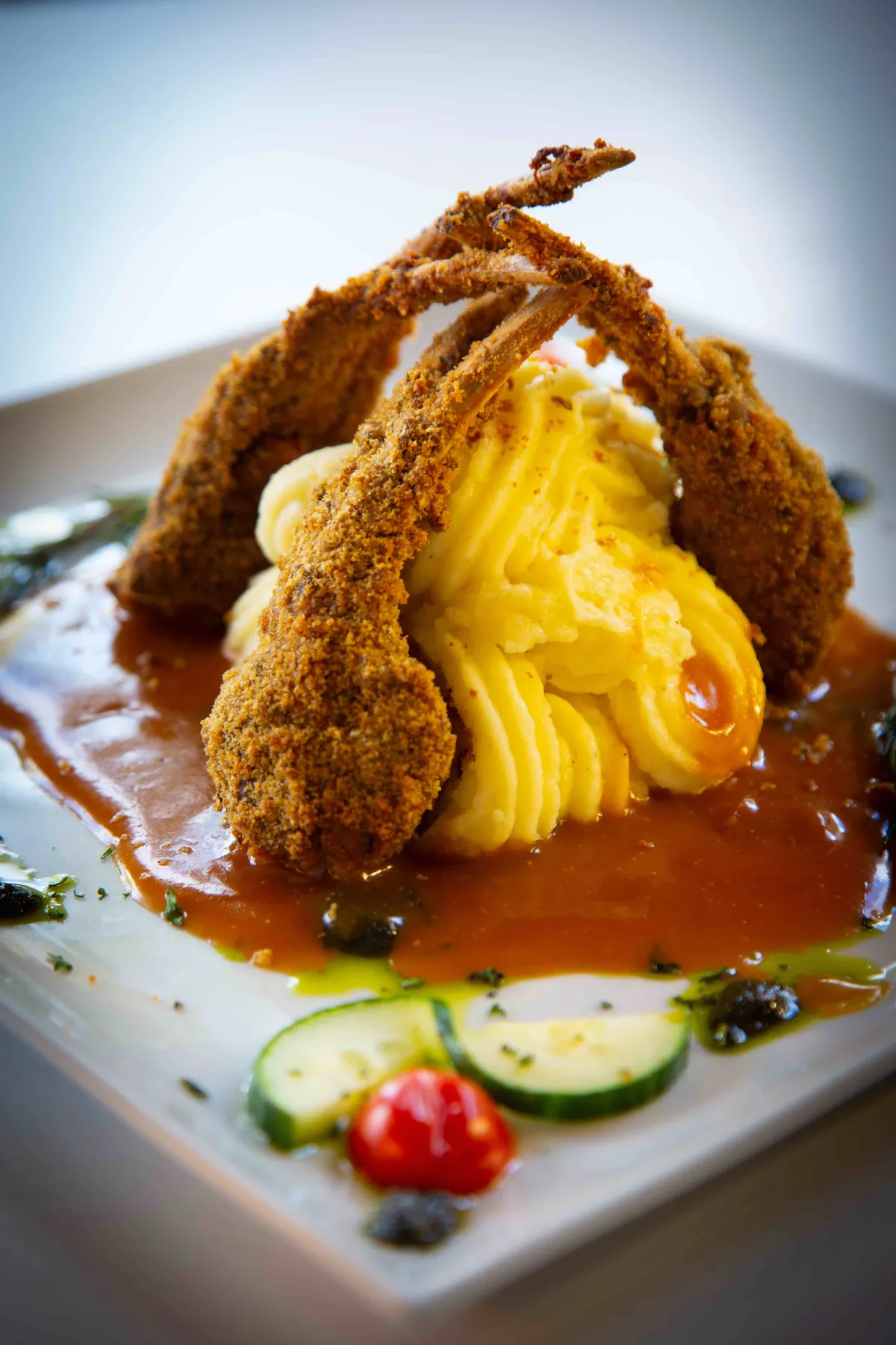 Herb-crusted rack of lamb over whipped potatoes and rich jus